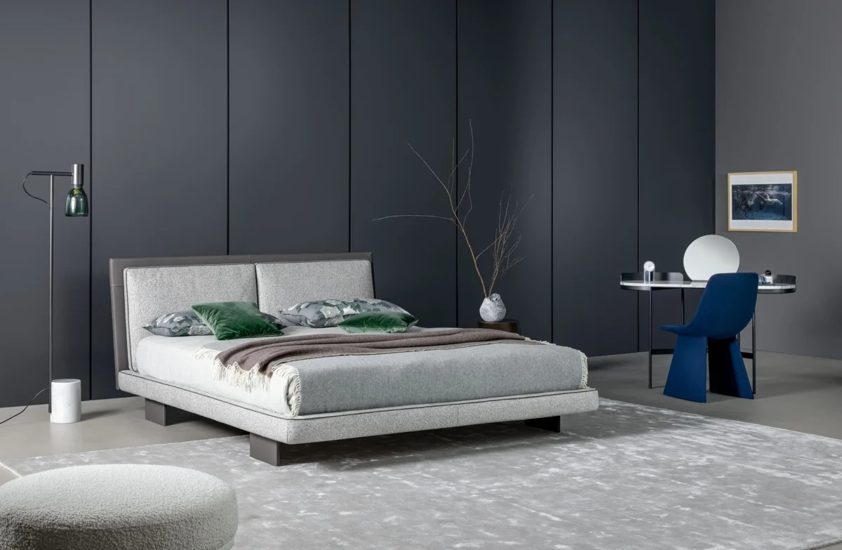Minimalist Tara bed by Bonaldo with dual cushion headboard, decorative leather border and linear upholstered frame