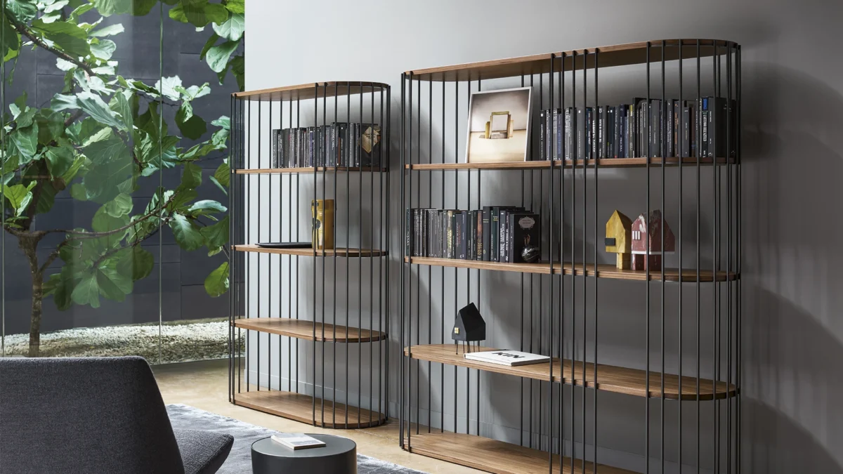 Pleated tear‑drop uprights on Bonaldo Dogma bookcase by Alain Gilles, with coal oak wood shelving and metal frame options