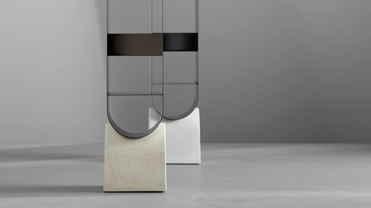 Modern Vague bookshelf by Bonaldo, combining a gray concrete base with a metal structure in supreme anthracite finish, offering versatile storage solutions.