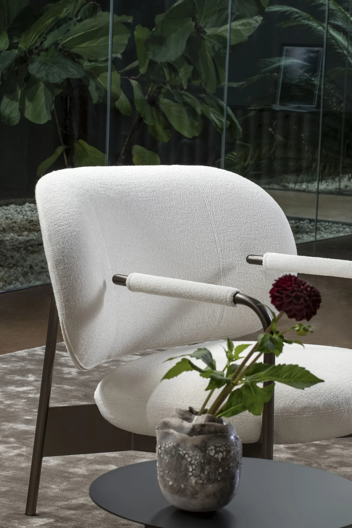 Bonaldo Cross Lounge Chair with graphic metal armrest tube – bent forward then stopping just before the upholstered back.