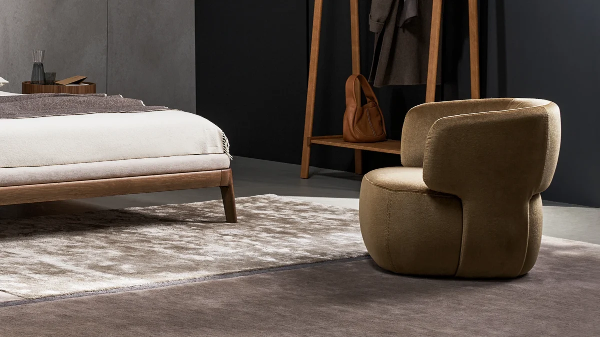 Bonaldo Doge fixed‑base armchair upholstered in rich leather with walnut legs and curved backrest