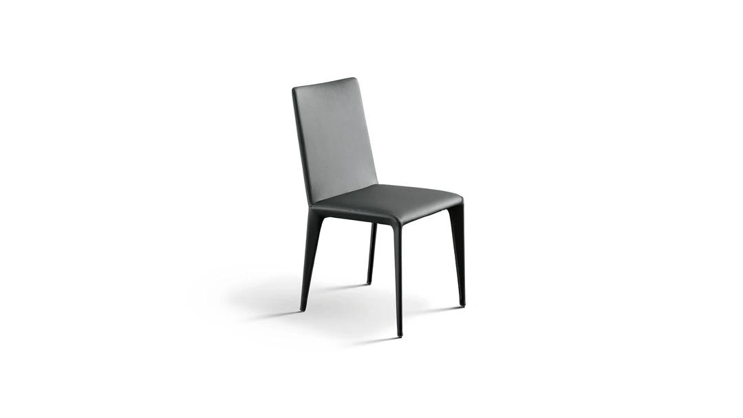 "Miss Filly chair in eco-leather with soft curves and contemporary styling on dark painted legs."