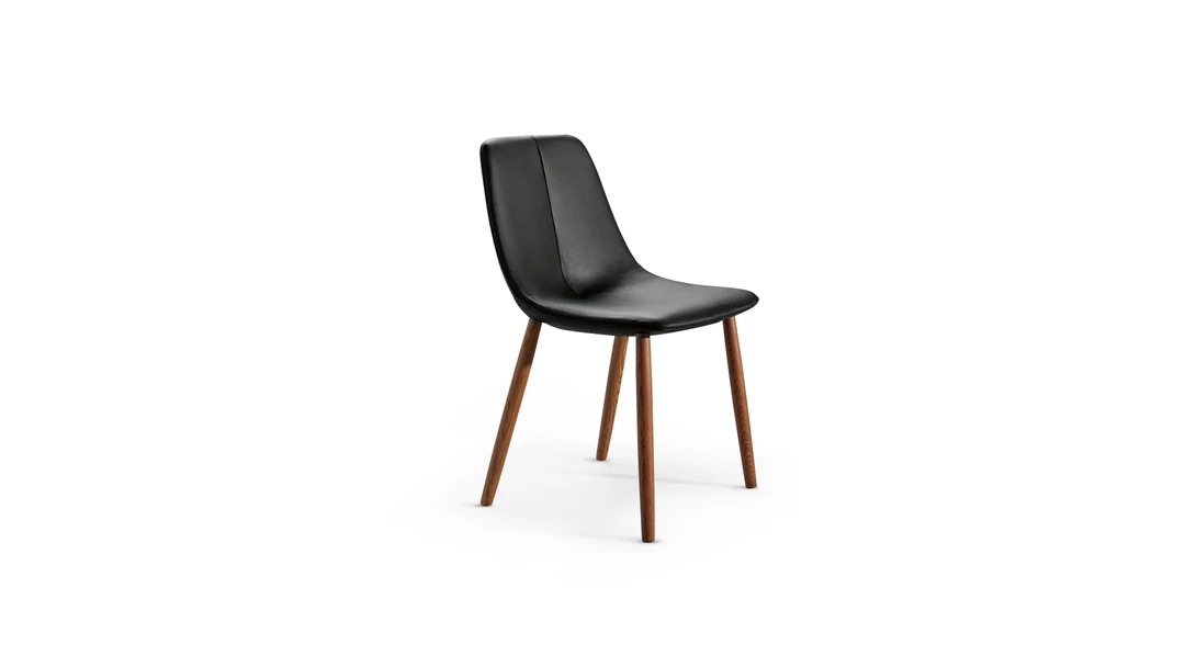 "By Met chair with plush seat and curved backrest, designed for both style and comfort."