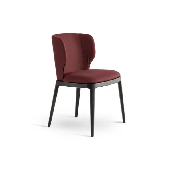 "High‑back Joy chair upholstered in leather, supported by durable solid wood legs in walnut finish."