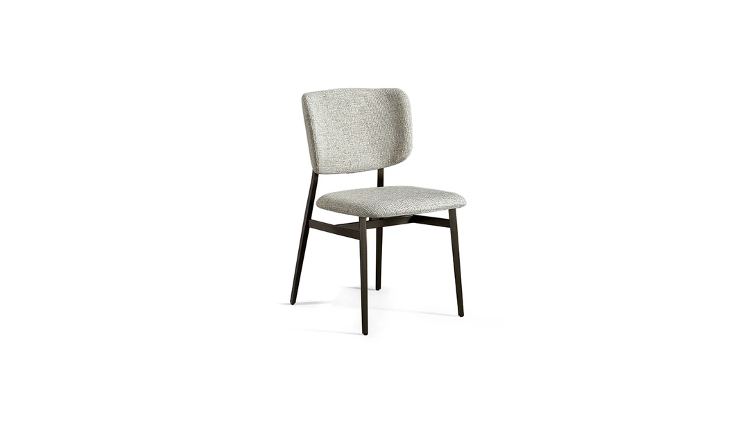 "Noor chair with slightly concave backrest and thin metal frame giving a refined, airy appearance."
