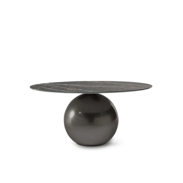 Side view showing spherical metal base supporting disc shaped marble table by Bonaldo
