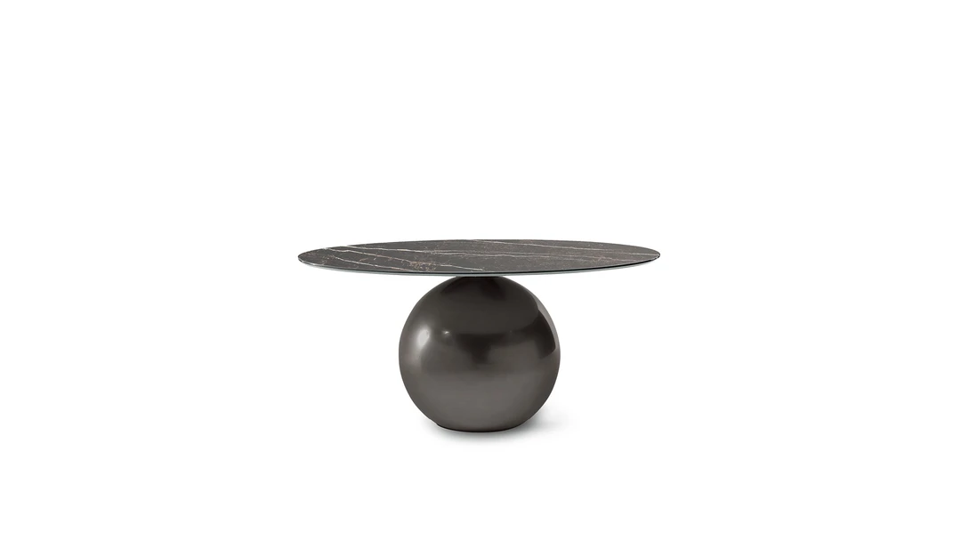 Side view showing spherical metal base supporting disc shaped marble table by Bonaldo