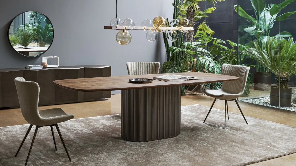 Bonaldo Dorian fixed table with elongated grooved cylinder leg supporting expansive oval stone surface