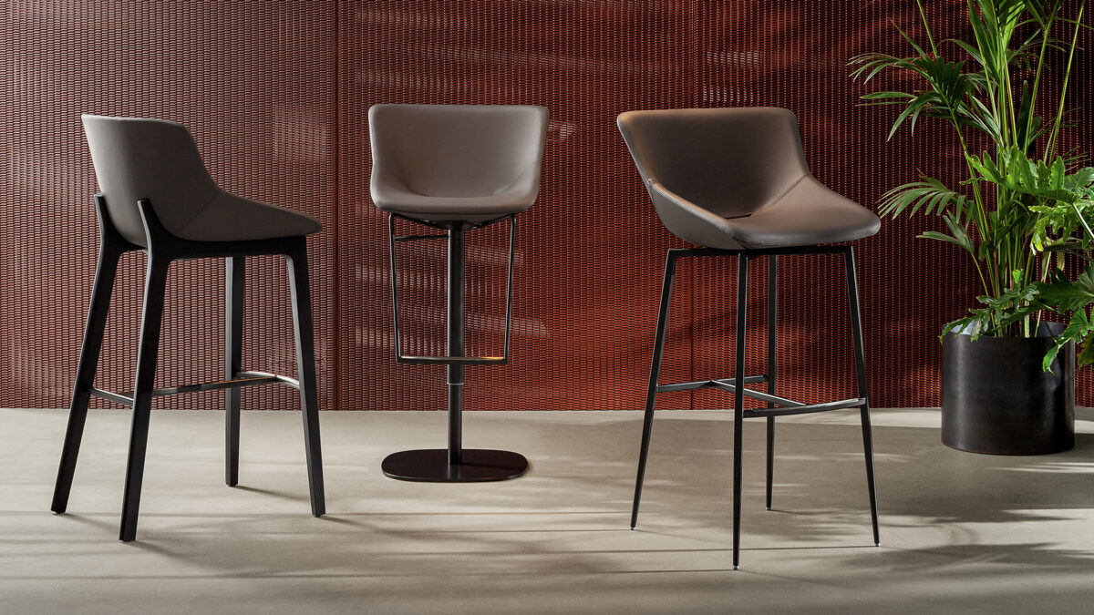 "Front view of Artika too chair highlighting its elegant, embracing shape and refined padding."