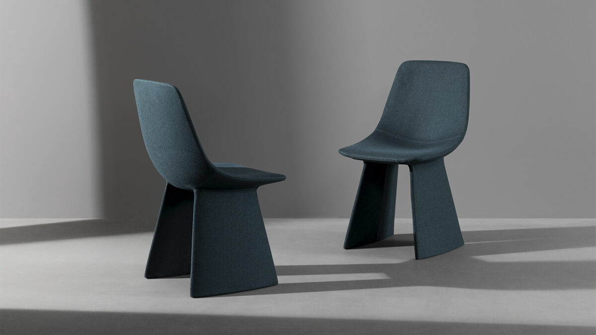 "Modern Agea dining chair in dark eco‑leather, featuring monolithic angled legs and a fully upholstered shell."