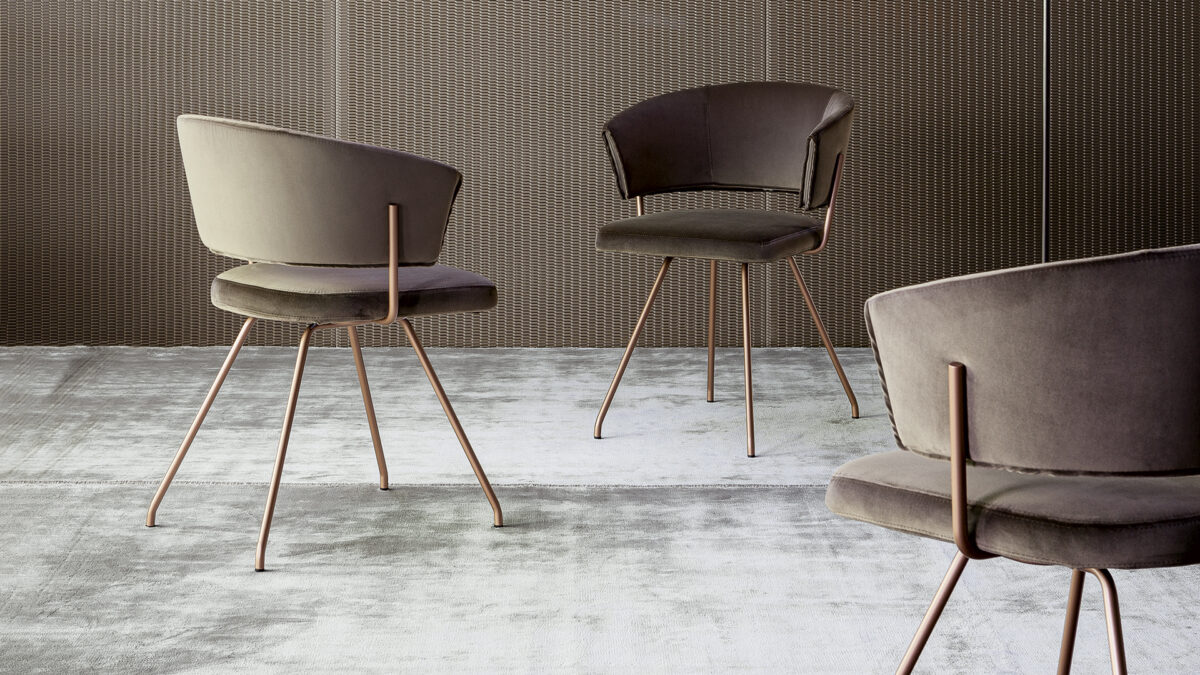 "Modern Bahia dining chair in soft upholstery with sculpted lines and elegant proportions."