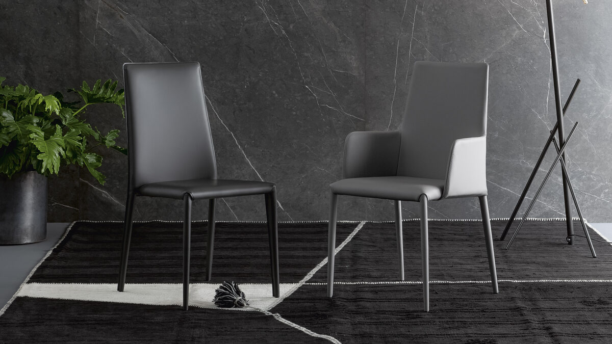 "Eral chair with seamless cushioning and stitched detailing, supported by minimalist legs."