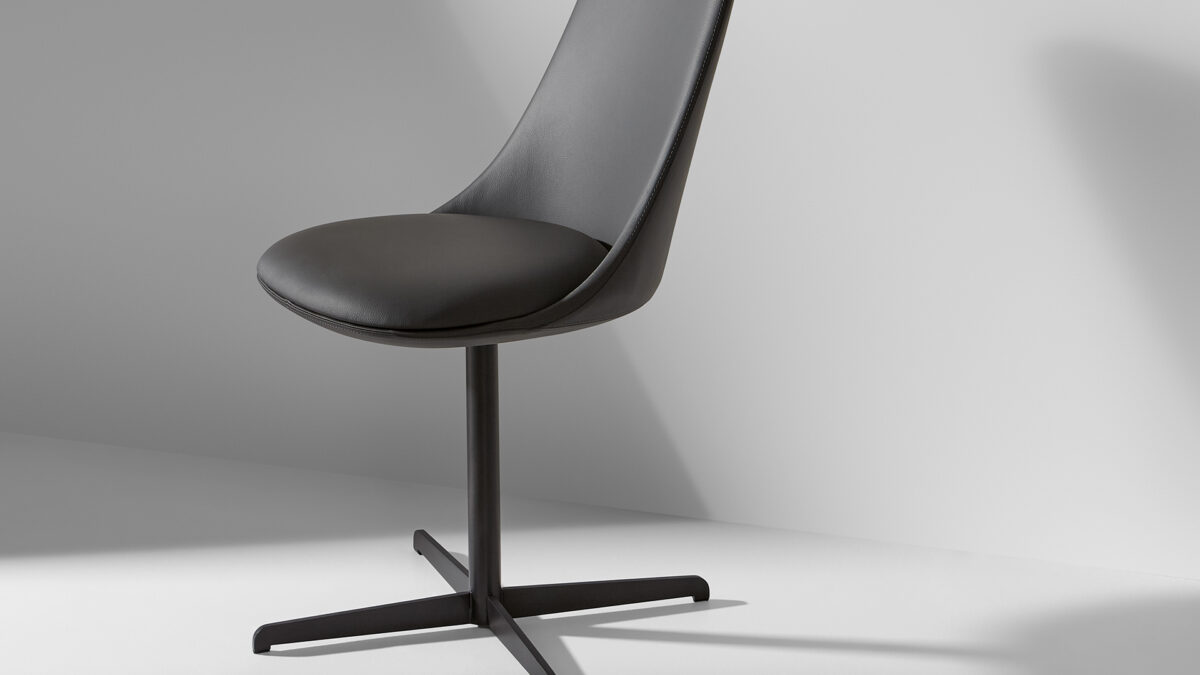 "Miss Itala Office chair by Bonaldo with wraparound armrests and padded back on a mobile swivel base."
