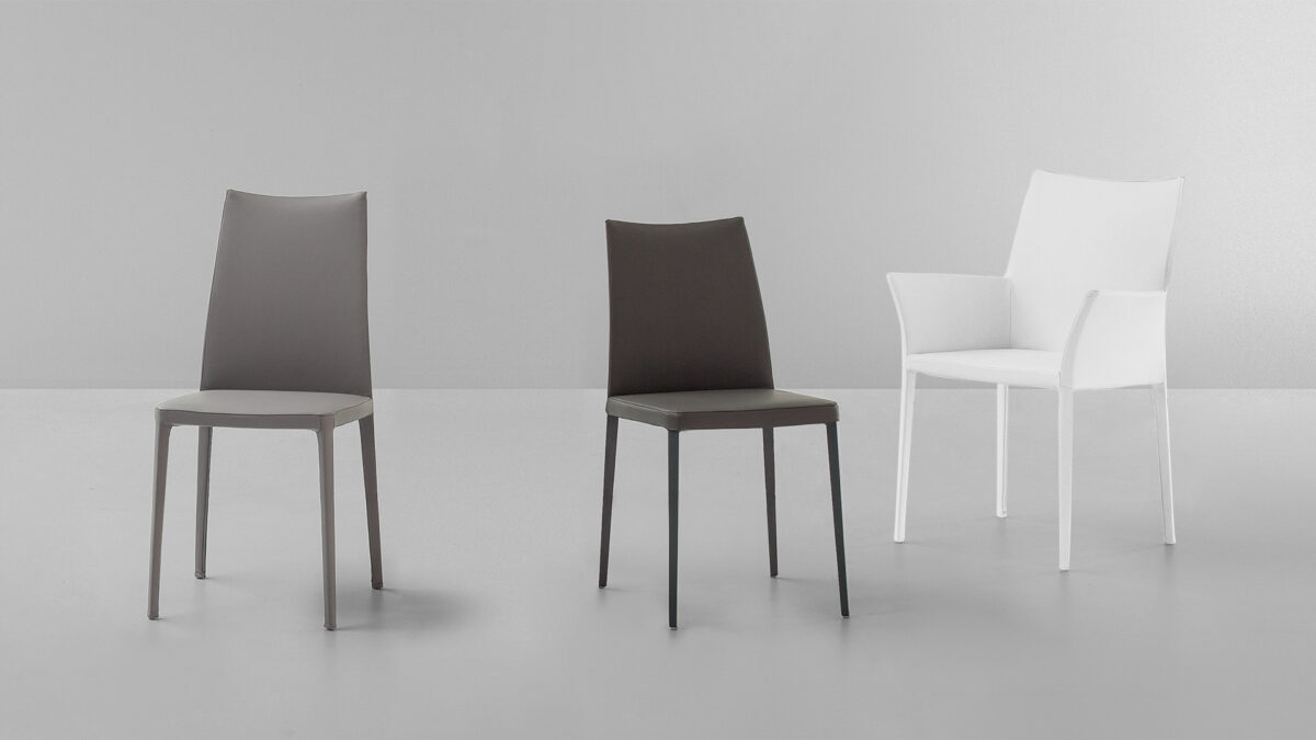 "Kayla chair by Bonaldo featuring a curved upholstered backrest and slender metal legs in matte black."