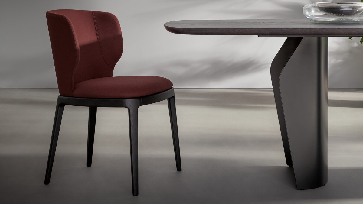 "Joy chair by Bonaldo with curved upholstered seat and backrest on a four‑leg solid ash wood base."