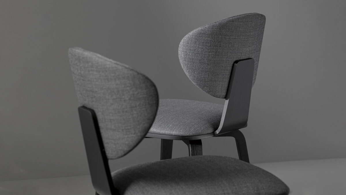 "Elegant swivel chair Olos by Bonaldo, showcasing a blend of wood and fabric materials."