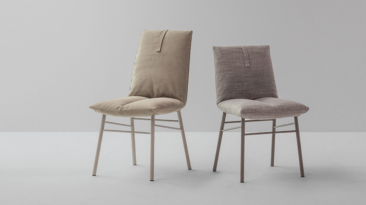 "Pill chair by Bonaldo with rounded cushioned backrest and metal legs in matte black finish."