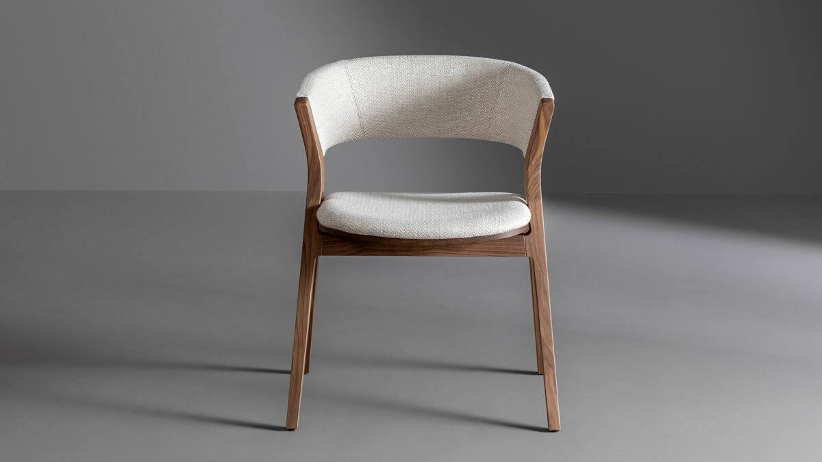 "Remo chair by Bonaldo featuring curved wooden frame and upholstered seat with elegant design."