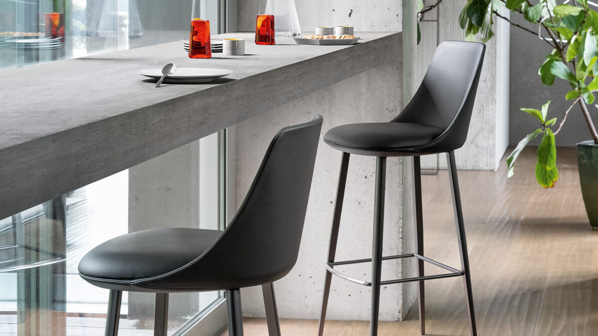 "Pair of Story People chairs around a round dining table in a contemporary home setting."