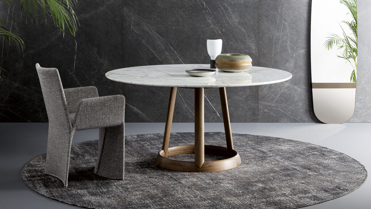 Side view of Greeny table showing balance between sculptural wood support and slender stone tabletop