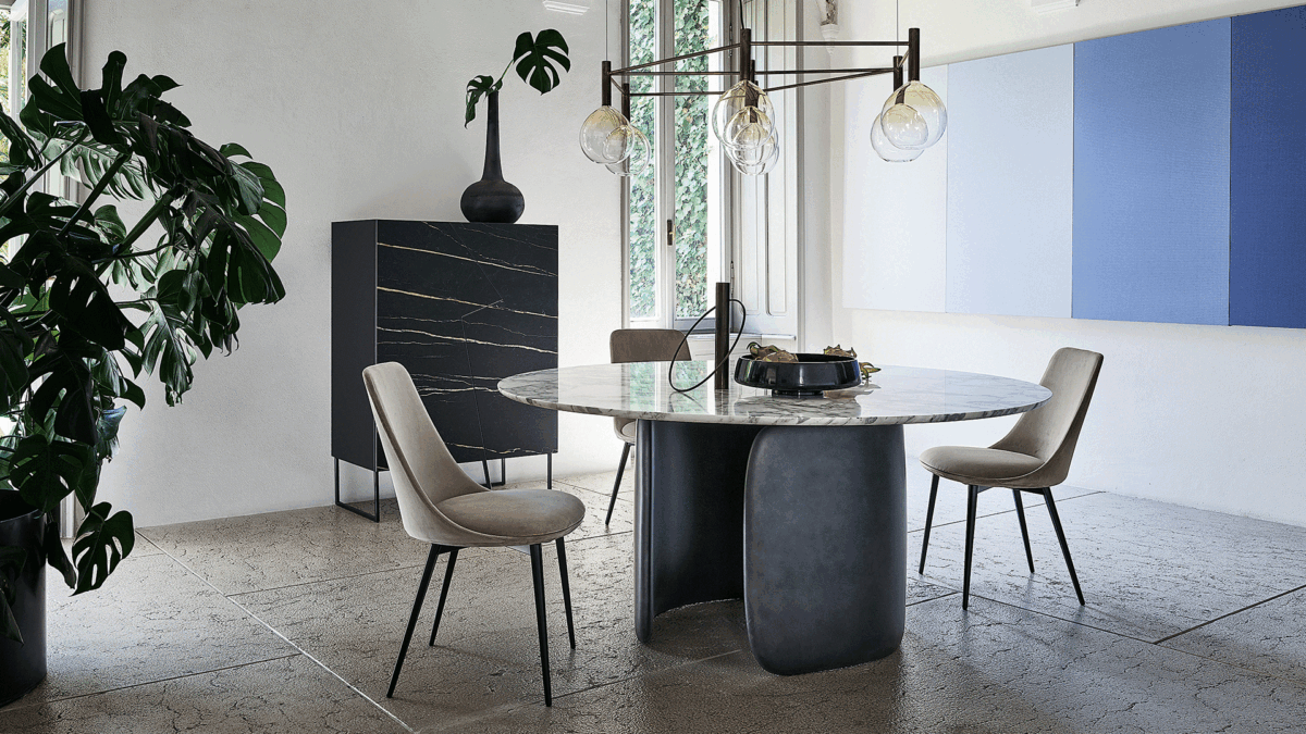 "Mellow dining table by Bonaldo with two curved polyurethane base modules embracing each other beneath a rounded-edge tabletop."