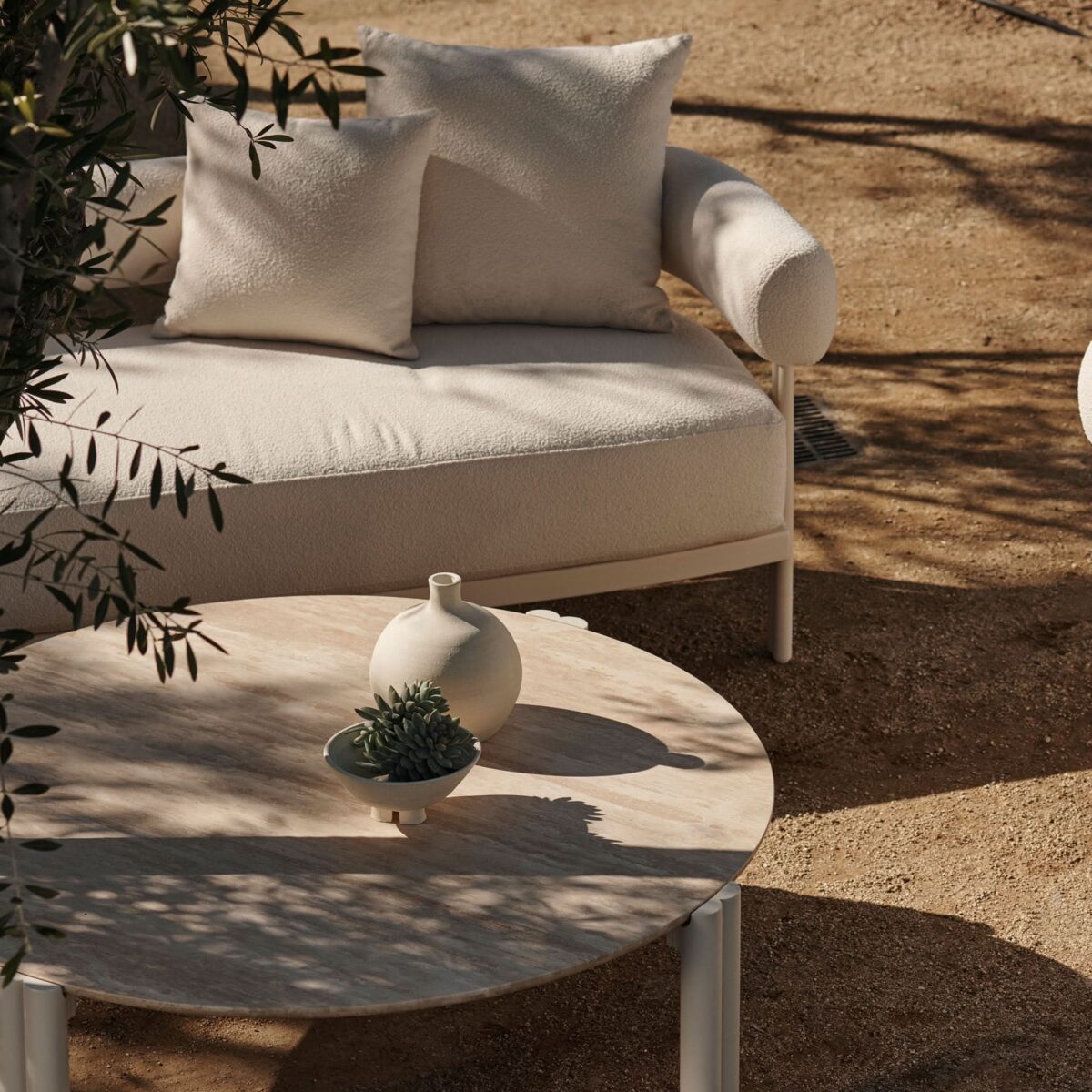 “Side profile of Harbour’s Cove Round Coffee Table – low-profile aluminum form ideal for outdoor settings”