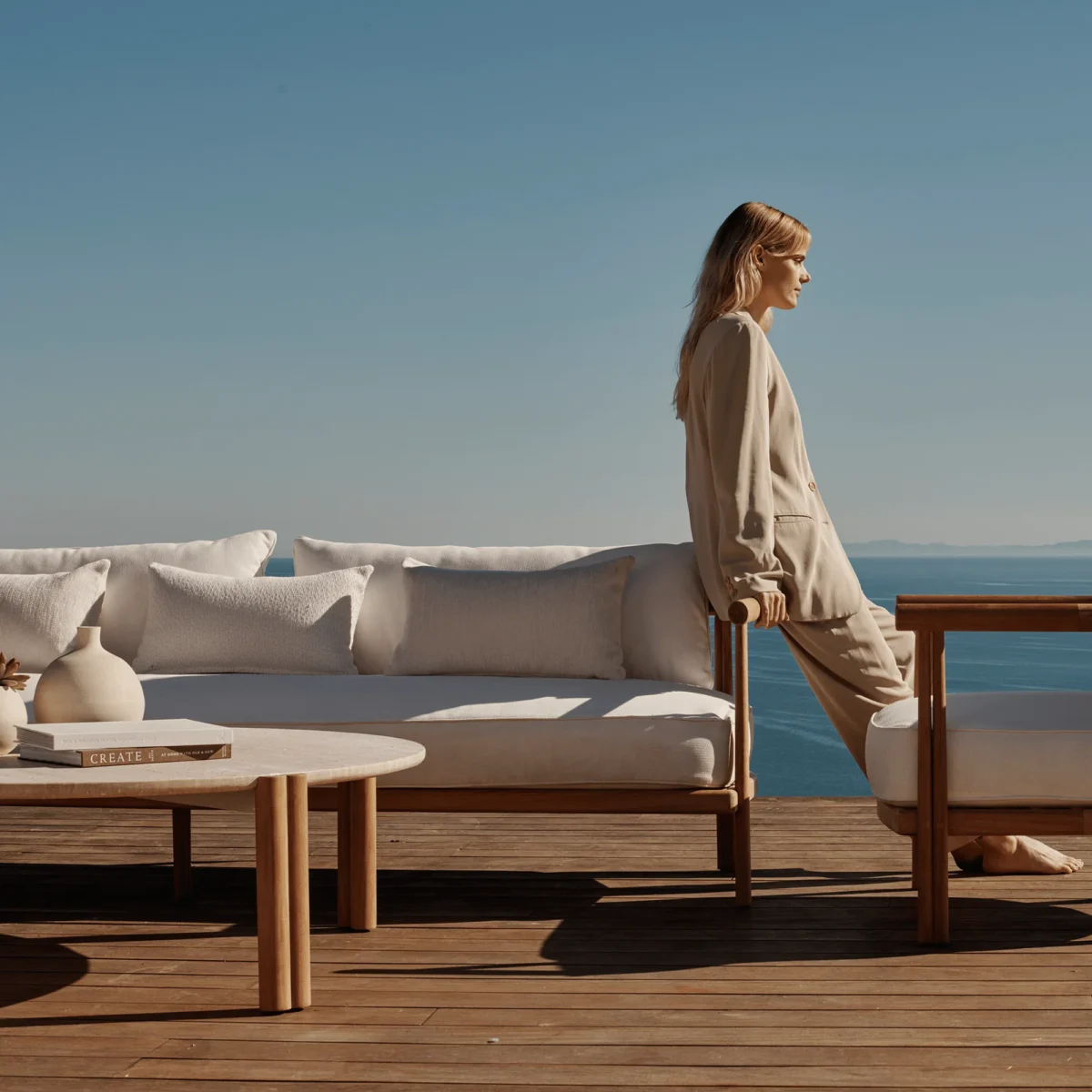 “Modern teak round coffee table by Harbour – Cove collection featuring sculptural simplicity for outdoor use”