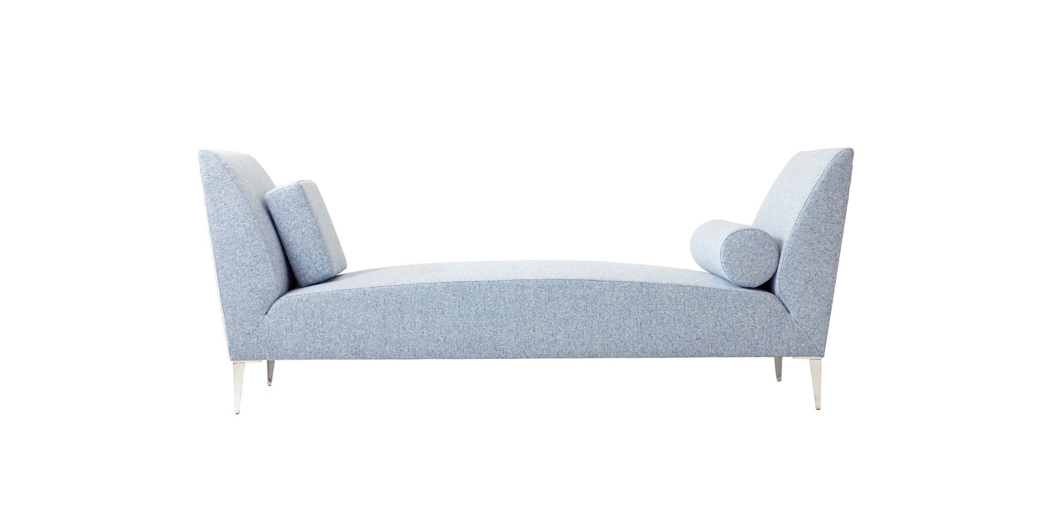 “Overhead perspective of the Daybed’s rectangular profile and symmetrical arm bolsters against a neutral rug.”