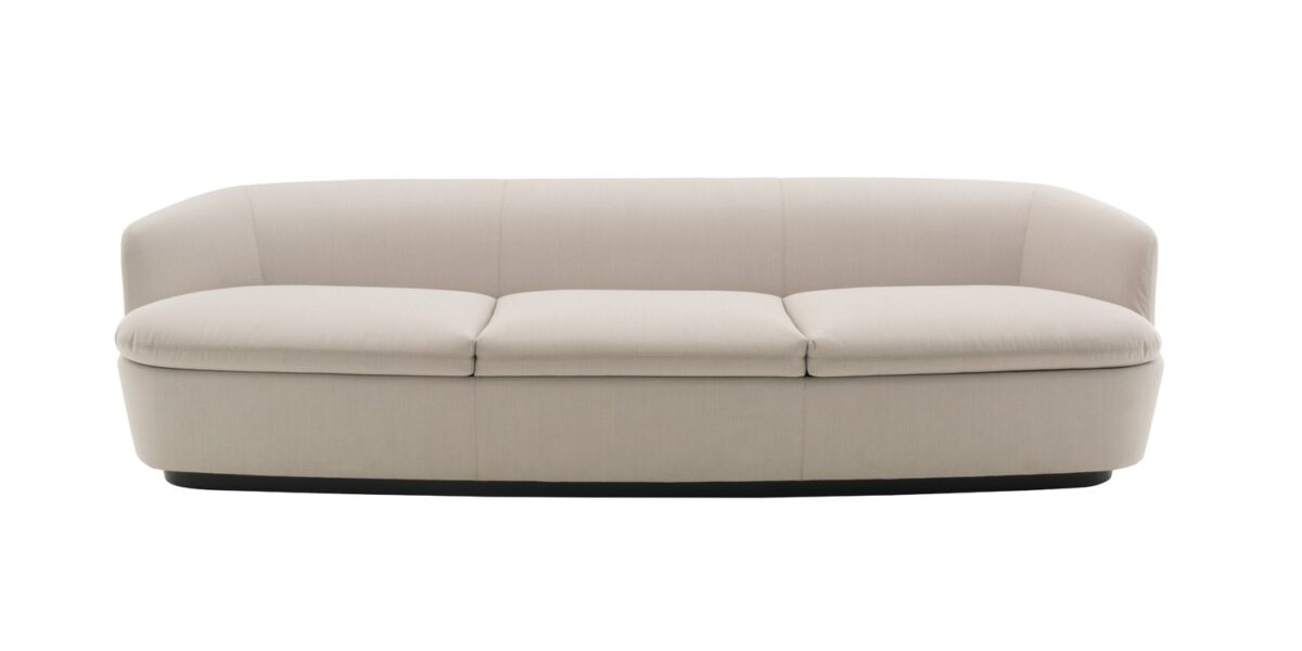 “Detailed shot of Orla’s swivel base and organic curves, upholstered in rich dark leather.”