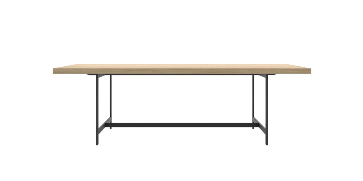 “Lochness Table in a commercial lounge, featuring a 300 × 90 cm natural oak top on matte‑white base, with white plastic feet visible.”