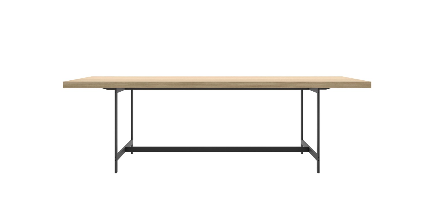 “Lochness Table in a commercial lounge, featuring a 300 × 90 cm natural oak top on matte‑white base, with white plastic feet visible.”
