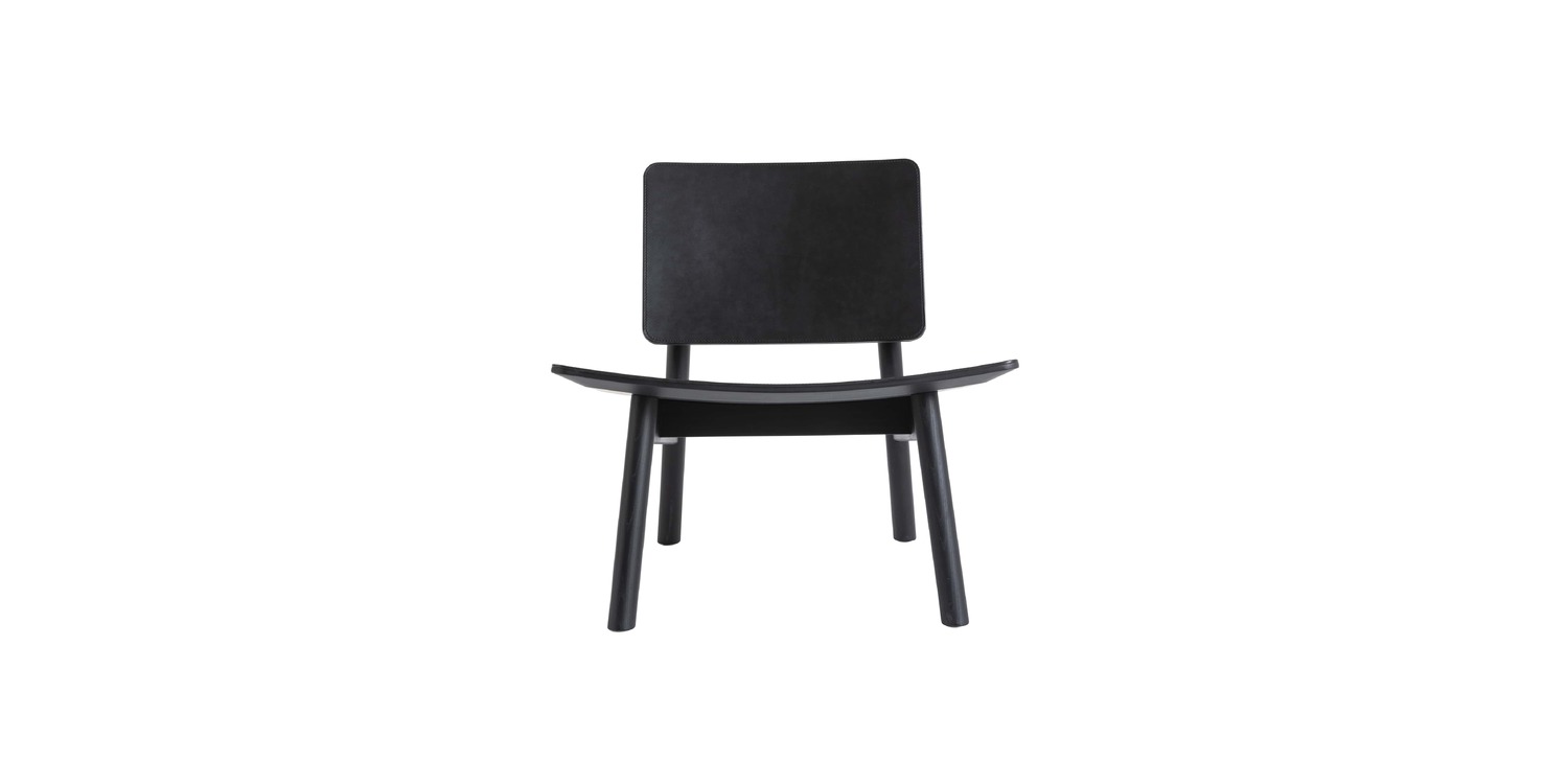 "Hiroi Armchair with saddle leather upholstery in a well-lit interior space, highlighting its elegant design."