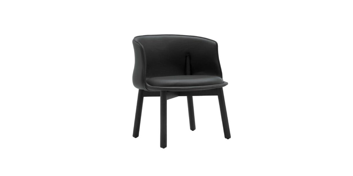 "Peg Armchair photographed in natural light, showing warm-toned upholstery contrasted with ash wood legs."