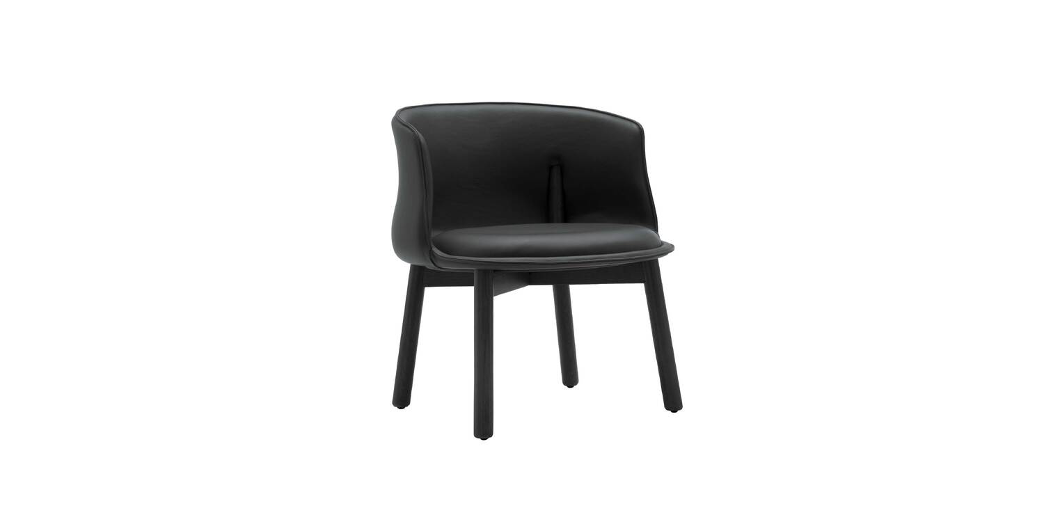 "Peg Armchair photographed in natural light, showing warm-toned upholstery contrasted with ash wood legs."