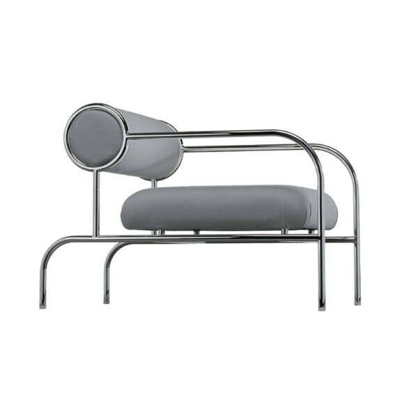 "Cozy corner setting with Cappellini sofa with arms, upholstered in velvet and set against a neutral backdrop."