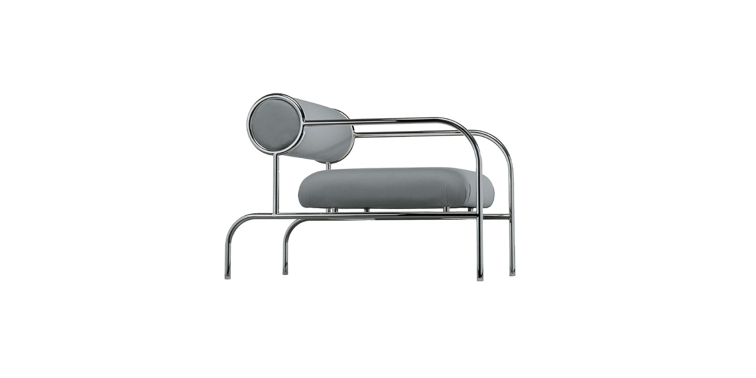 "Cozy corner setting with Cappellini sofa with arms, upholstered in velvet and set against a neutral backdrop."