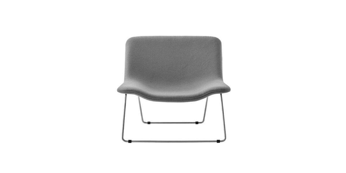 "Contemporary reading corner featuring a Spring armchair with contrasting front/back fabric colors."
