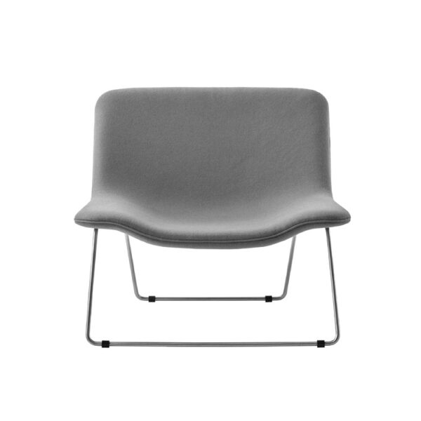 "Contemporary reading corner featuring a Spring armchair with contrasting front/back fabric colors."