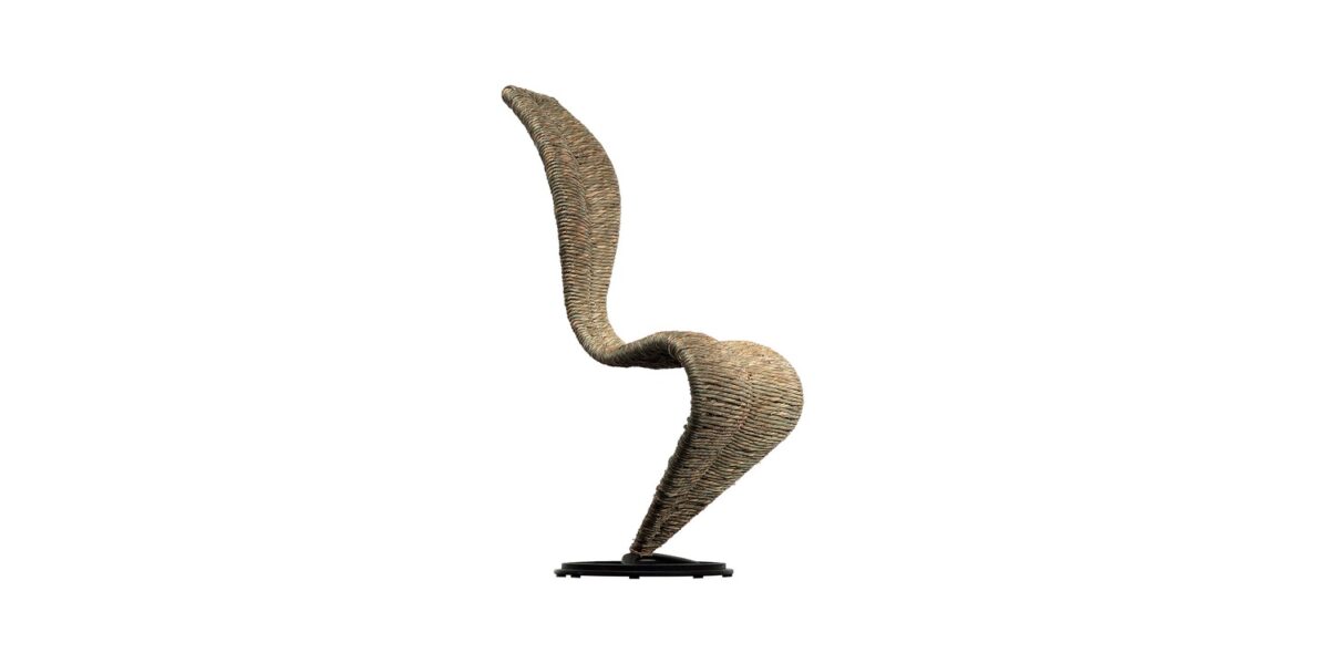 "Detailed shot of the joint where the S‑Chair’s tubular legs meet the woven seat, highlighting industrial finishing."
