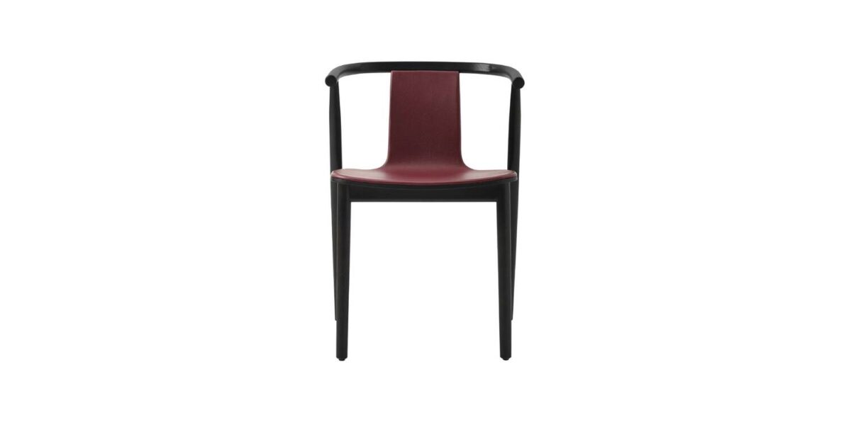 "Detail shot of the curved backrest and black polypropylene foot on a fabric‑front Bac chair."