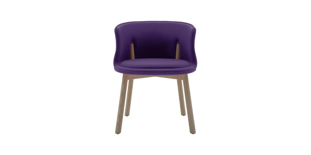 "Detail shot of the Peg Chair’s rigid foam shell and co-injected polyurethane cushion on ash legs."