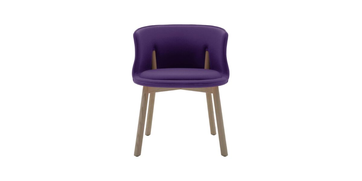 "Detail shot of the Peg Chair’s rigid foam shell and co-injected polyurethane cushion on ash legs."
