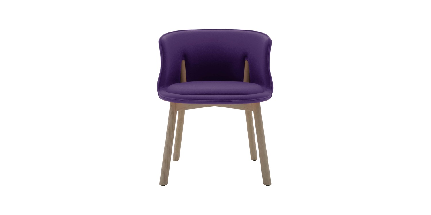 "Detail shot of the Peg Chair’s rigid foam shell and co-injected polyurethane cushion on ash legs."