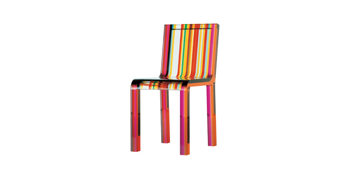 "Close‑up of the Rainbow Chair’s polished edge where multiple colored methacrylate sheets are ultrasonically bonded, revealing a glossy finish."