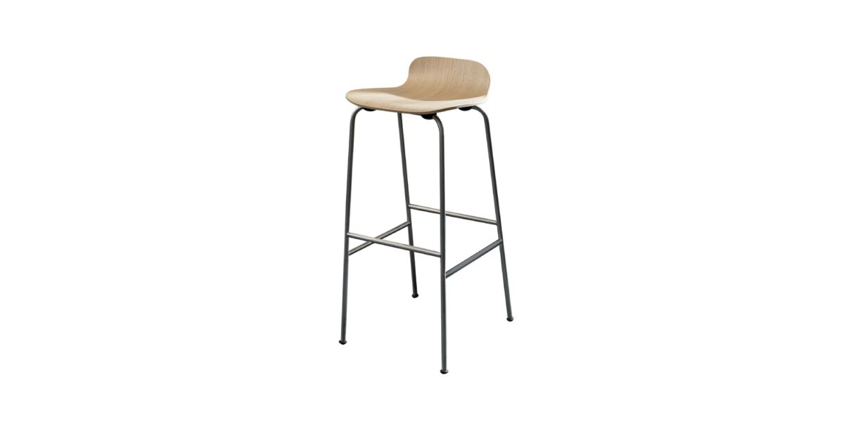 “Close-up of the curved plywood backrest and edge detailing on a Tate Wood stool with white-stained veneer and polished sled base.”