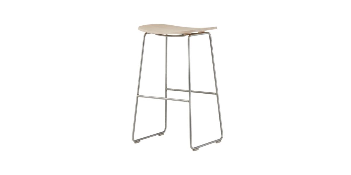 “Detail shot of footrest support brace and polypropylene foot caps beneath a high Morrison Stool.”