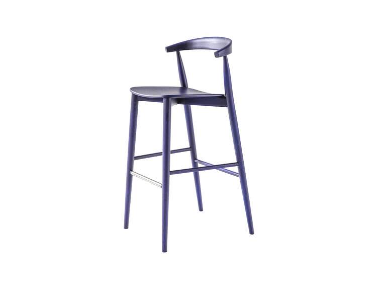 “Studio setting with Newood Light Stool in bleached ash beside a wooden table, casting soft shadows on a neutral floor.”