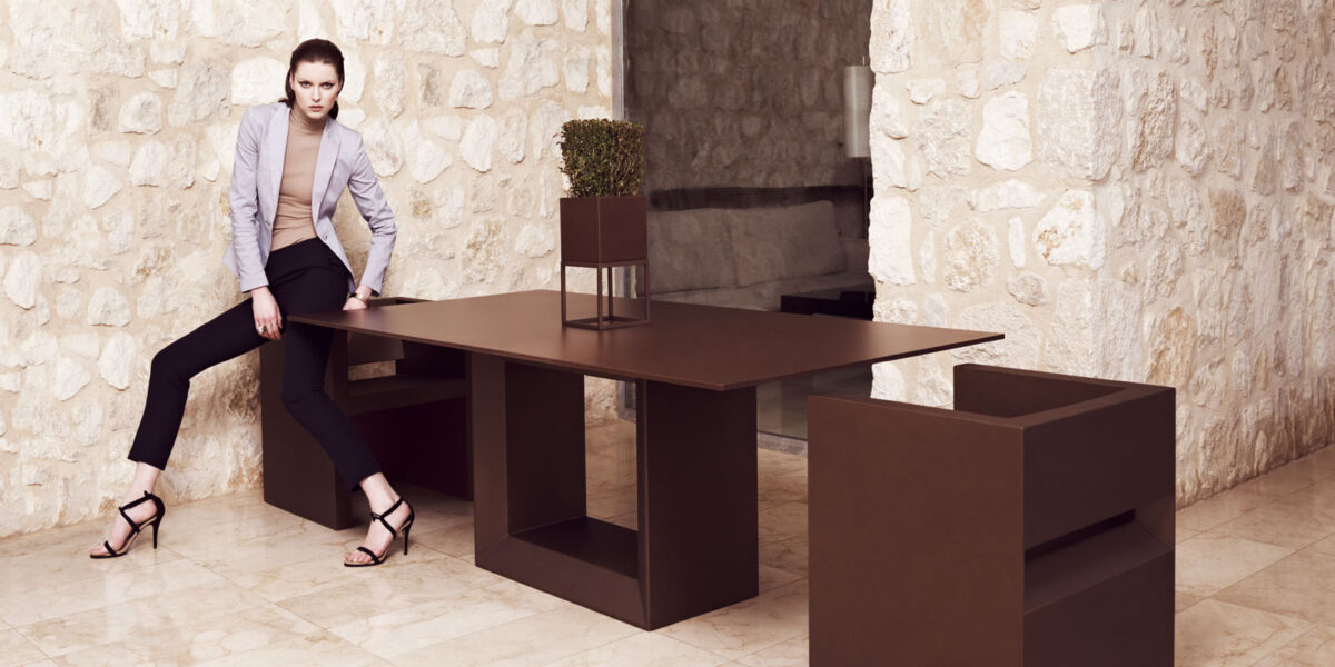 "VELA dining table by Vondom featuring clean lines and minimalist geometric form."