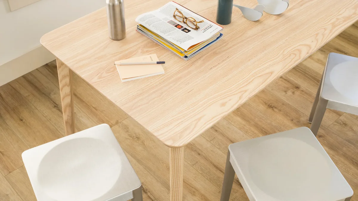 Lancaster Chair by Emeco, designed by Michael Young, offering a blend of sustainability and modern design with its solid ash wood frame and recycled aluminum components.