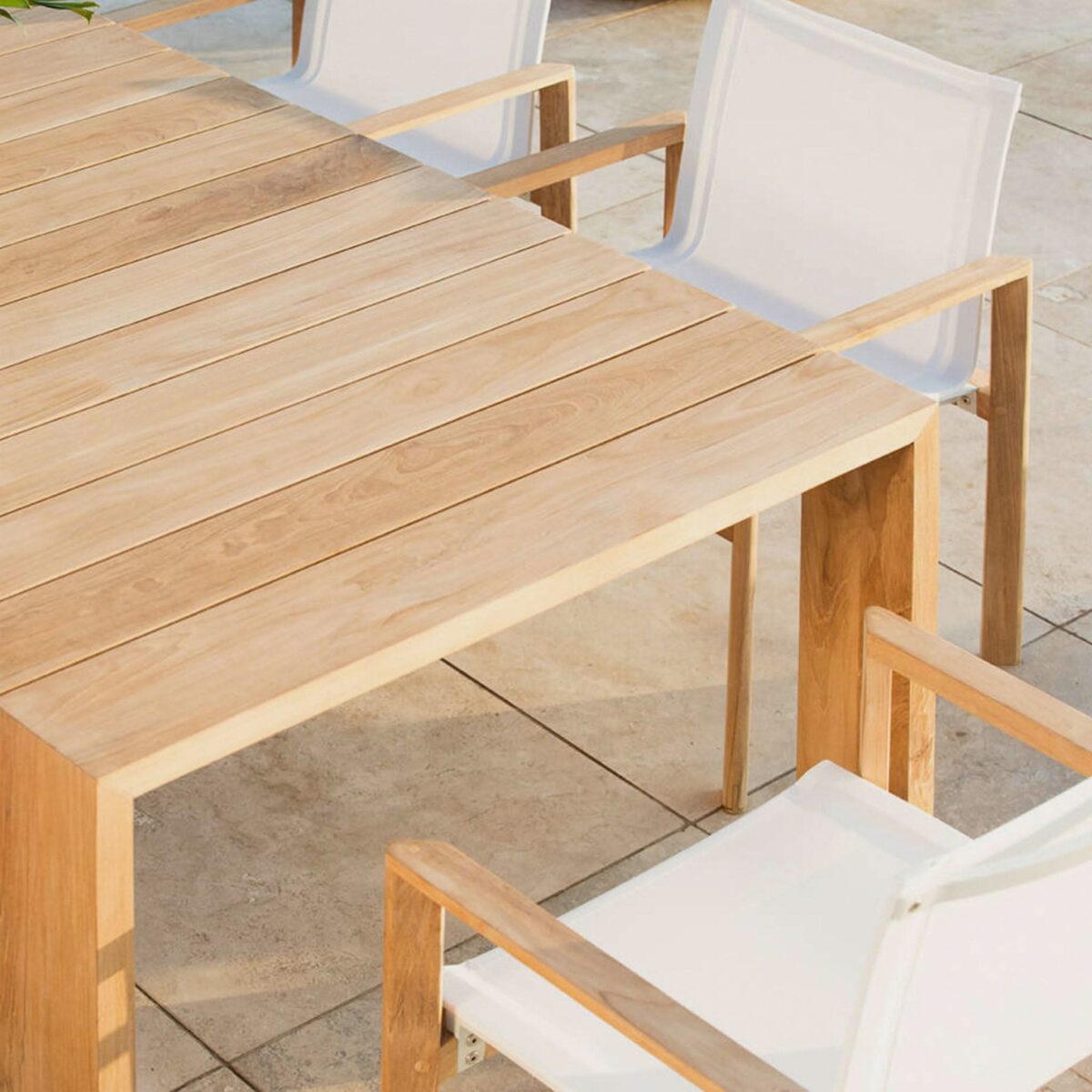 “Angled view of Hayman teak table – mid-size outdoor table ideal for stylish entertaining”